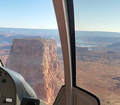 Helicopter landing on Tower Butte in Page Arizona with sweeping desert views