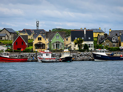 Colorful waterfront homes and fishing boats in Dingle, Ireland